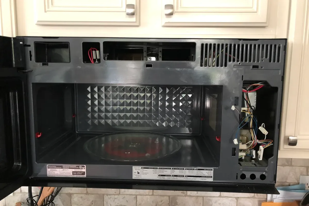 Over-the-range microwave being repaired by an Appliance Repair Now technician