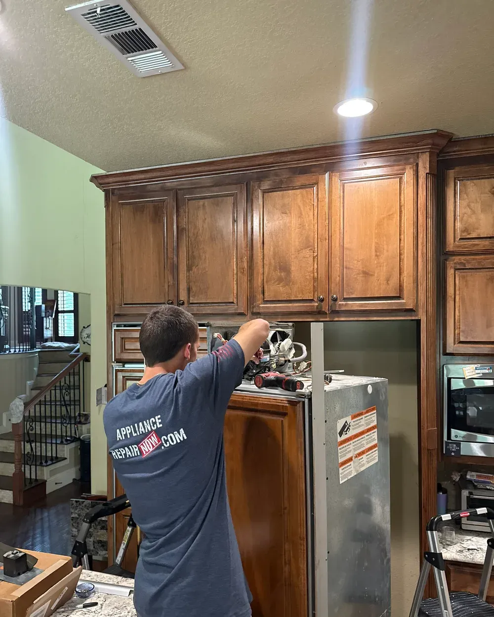Appliance Repair Now technician servicing a refrigerator