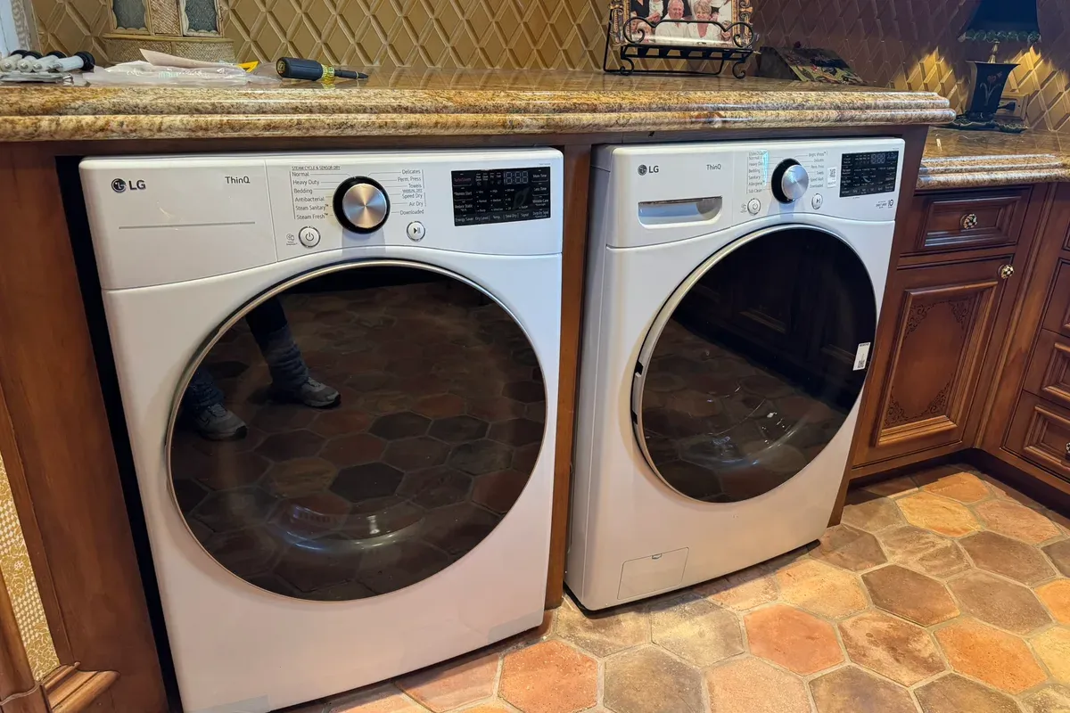Washer and dryer pair being serviced in a Fort Worth laundry room